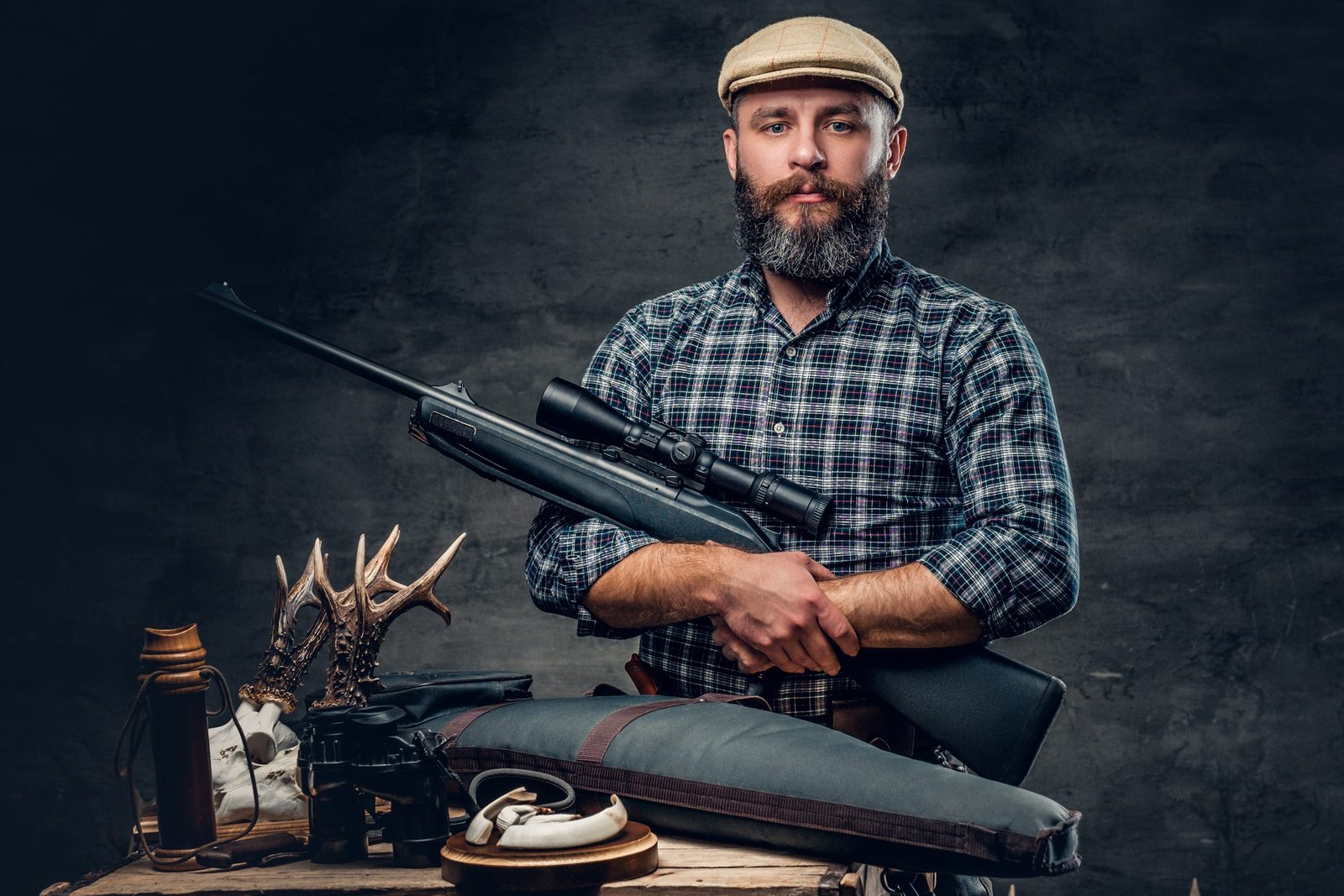man holding a hunting rifle with trophy